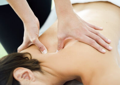 Young woman receiving a back massage in a spa center.